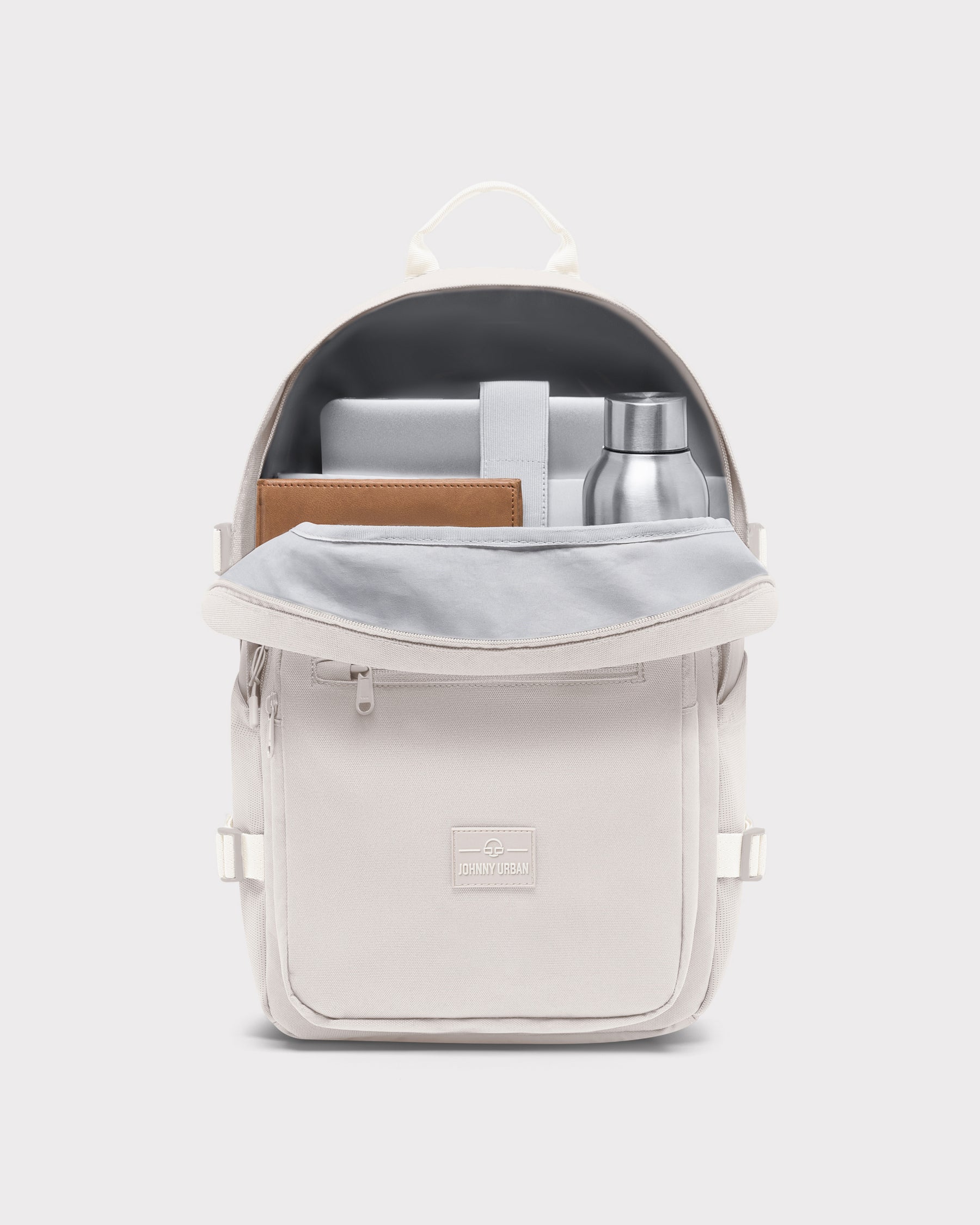 Sandfarbener Johnny Urban Rucksack 'Lian' mit geöffnetem Hauptfach, mit Laptop, braunem Notizbuch und silberner Trinkflasche