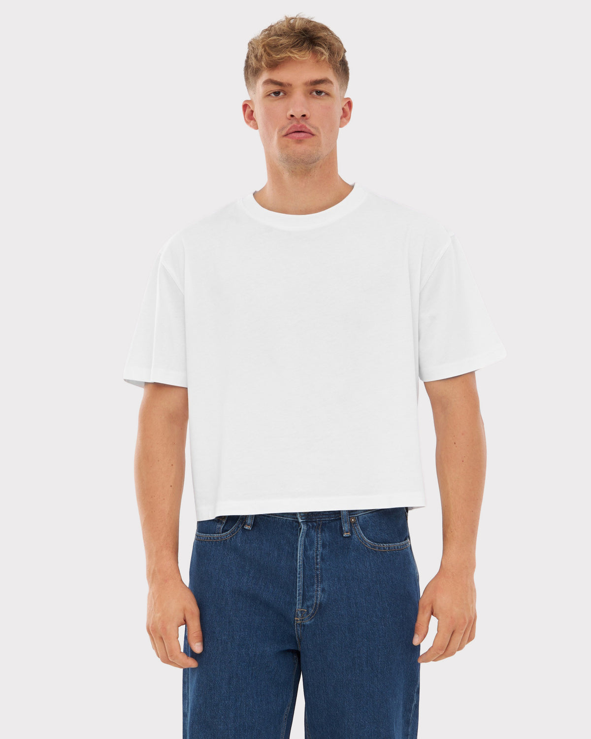 Mann trägt weißes Cropped T-Shirt 'Zoey' mit weitem Schnitt und kurze Ärmel