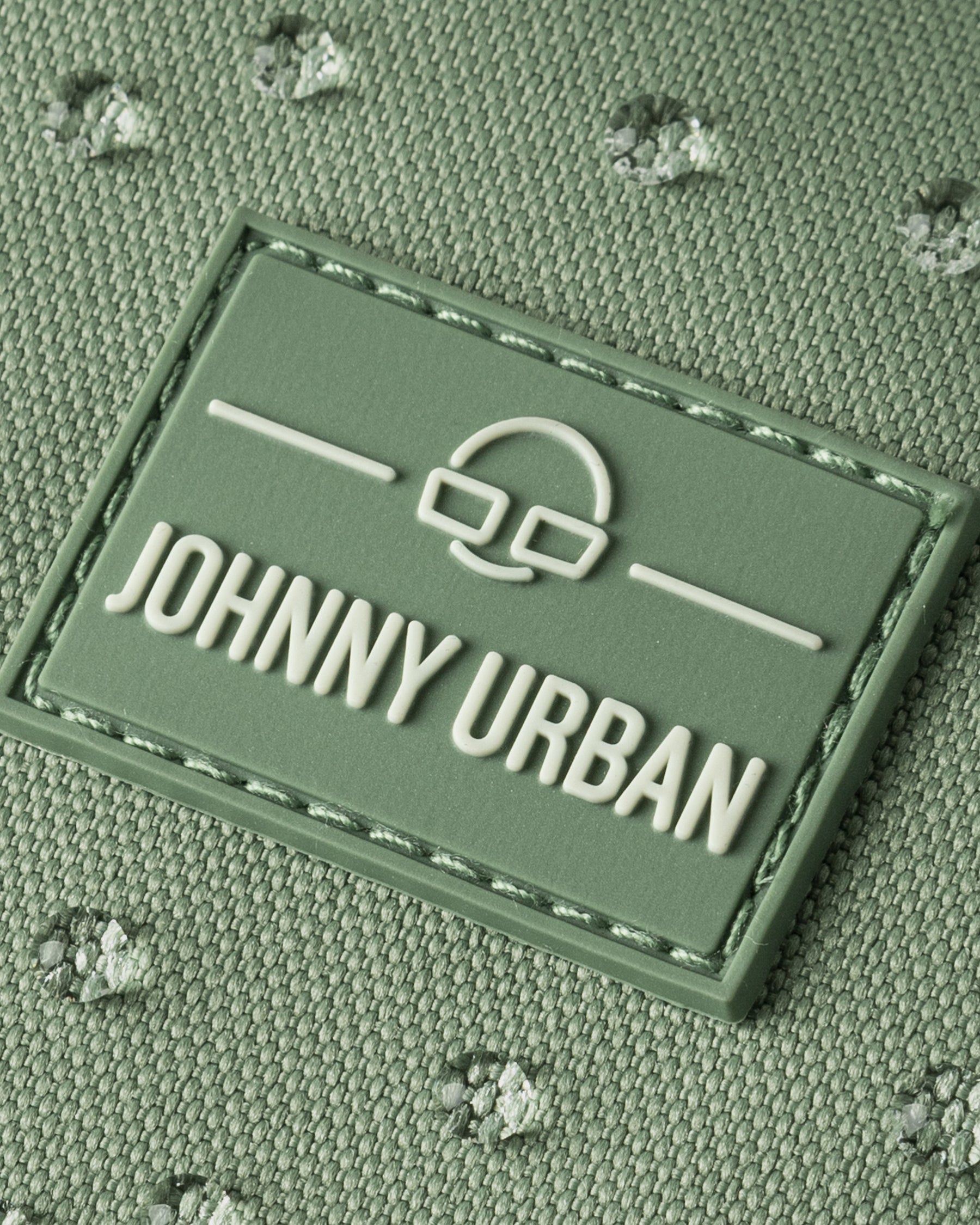 Nahaufnahme des wasserabweisenden, salbeigrünen Half Moon Bags "Ally Small" von Johnny Urban mit Logo-Patch