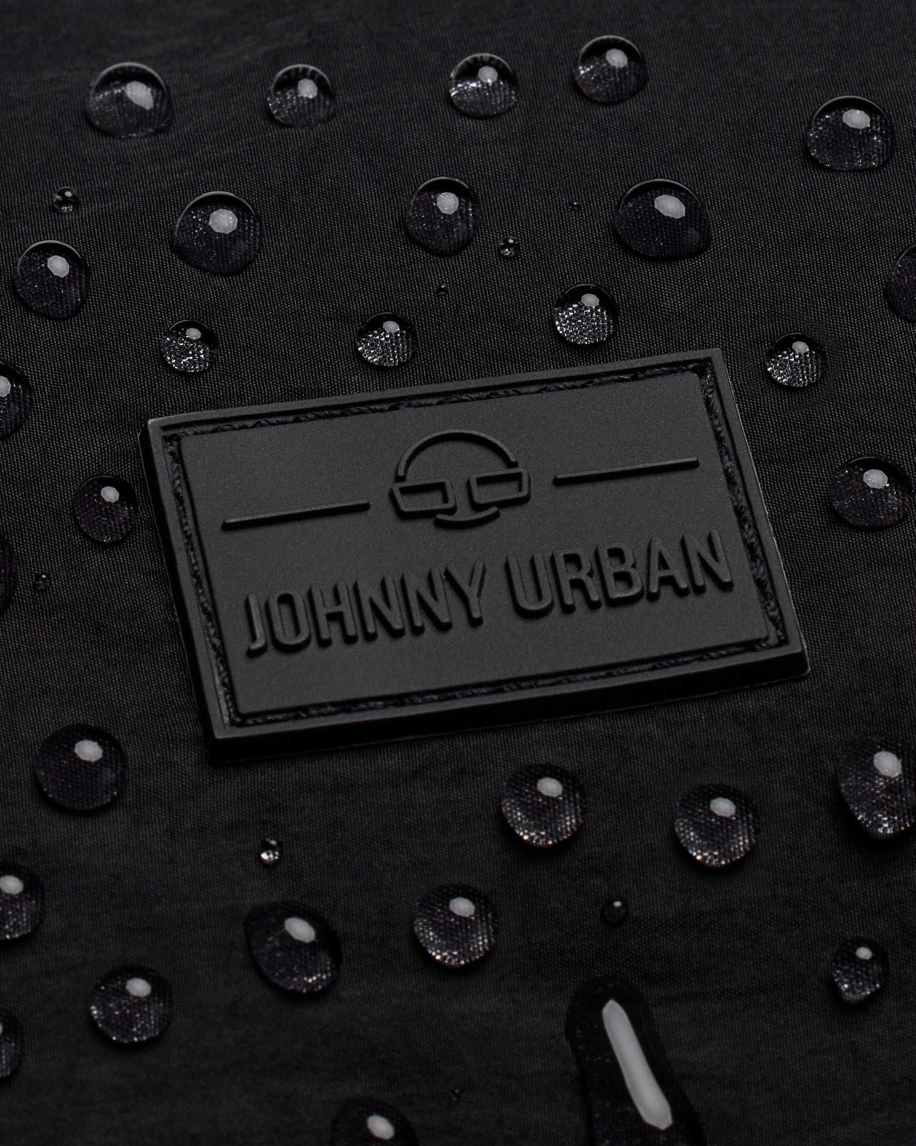 Wasserabweisendes schwarzes Material der Half Moon Bag 'Kaia Medium' mit Johnny Urban Logo und Wassertropfen