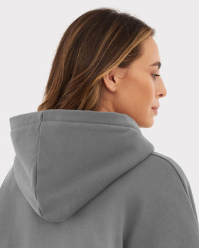 Frau mit hellbraunen Haaren von hinten in grauem, oversized Hoodie 'Cody' mit Kapuze