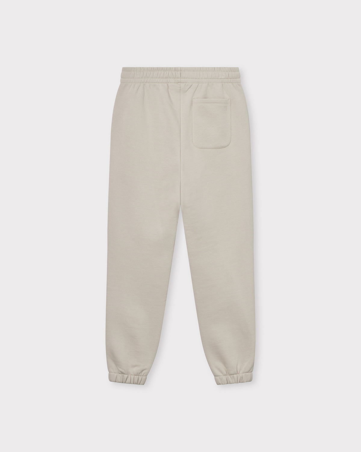 Beige Jogginghose "Owen" unisex mit elastischem Bund und elastischen Bündchen, mit einer Tasche hinten rechts