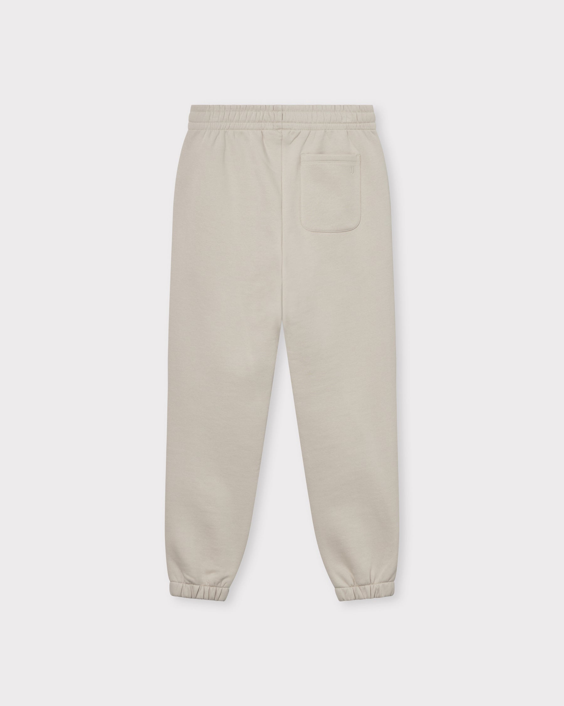 Beige Jogginghose "Owen" unisex mit elastischem Bund und elastischen Bündchen, mit einer Tasche hinten rechts