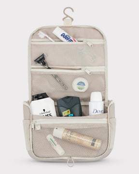 Beige Kulturtasche 'Logan' mit transparenter Aufteilung, Zahnbürste, Zahnpasta, Rasierer und Pflegeprodukten