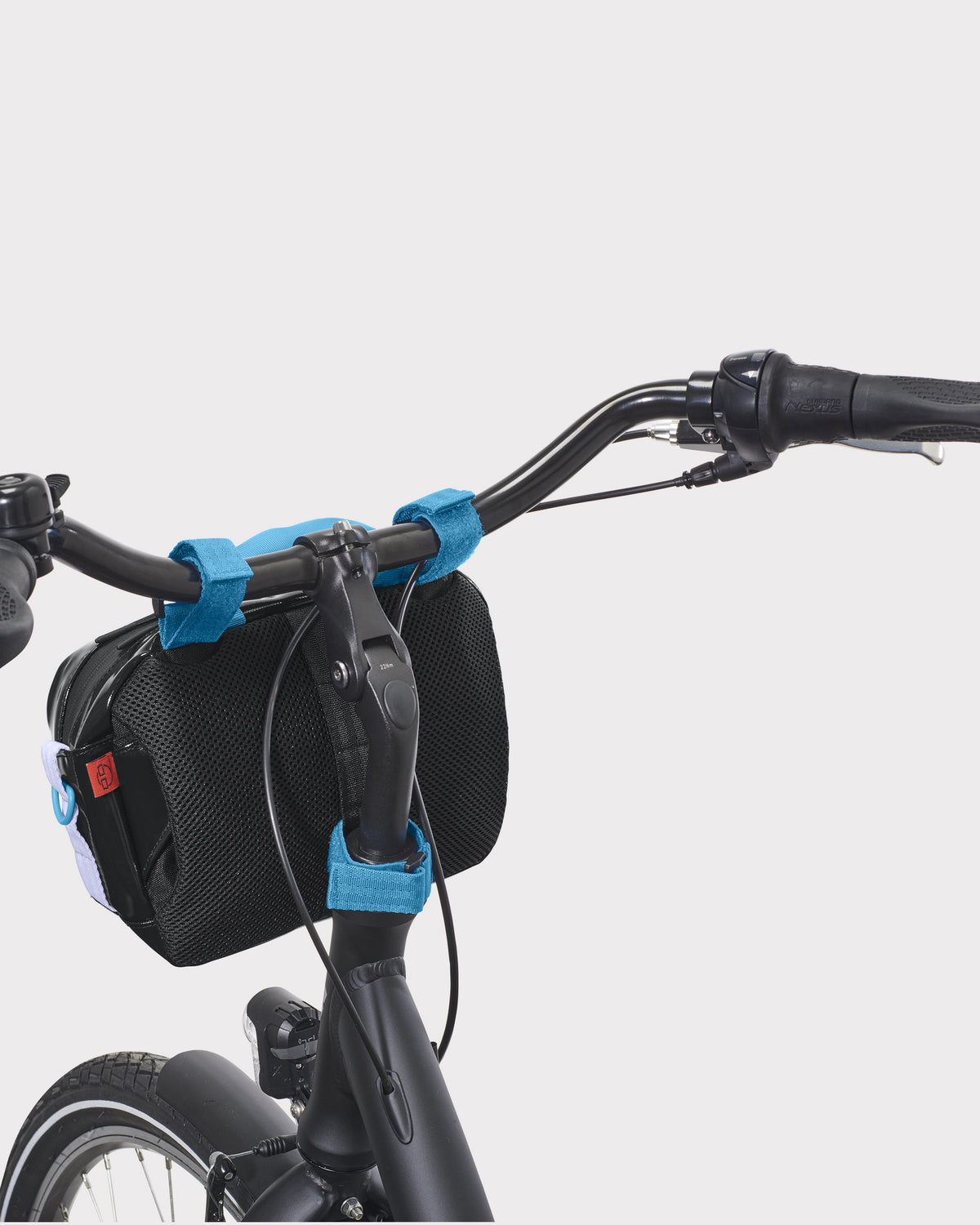 Schwarze Fahrrad-Lenkertasche 'Nelson' mit blauen Klettverschlüssen am schwarzen Lenker befestigt