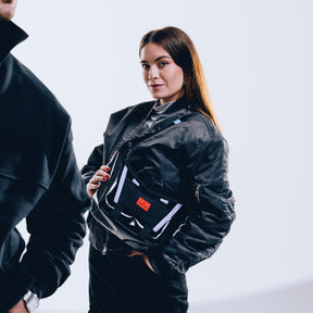 Frau trägt schwarze Handtasche 'Liv' von Johnny Urban über der Schulter, schwarze Jacke