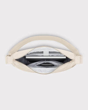 Geöffnete Half Moon Bag 'Ally XL' zeigt Laptopfach und Reißverschlusstasche in beigem Material