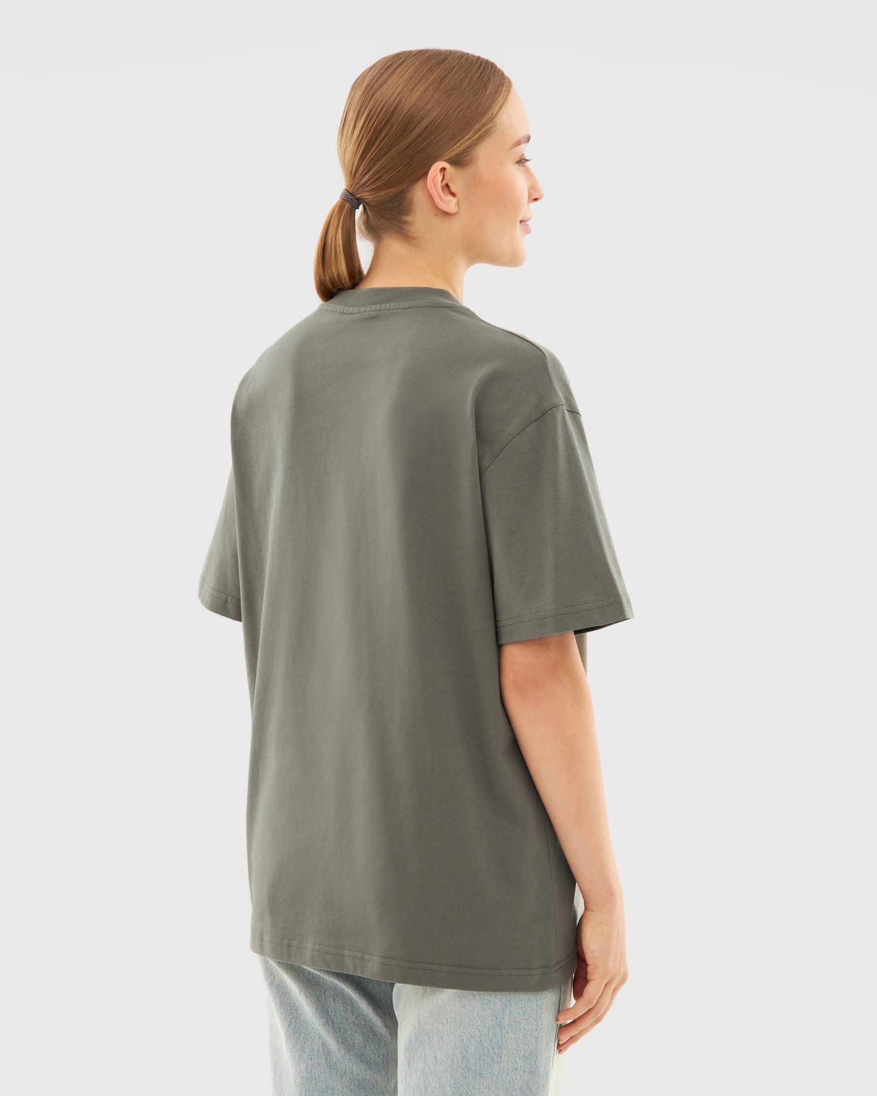Frau trägt oversized T-Shirt 'Sammy' in grauer Olive-Farbe, Rückansicht