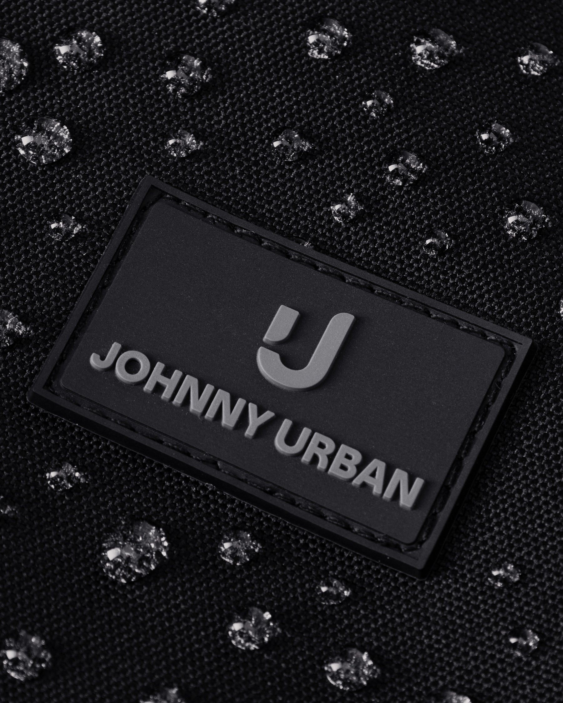 Schwarzes Johnny Urban Logo auf wasserdichtem Stoff mit Tropfenmuster der Weekender Reisetasche Milan