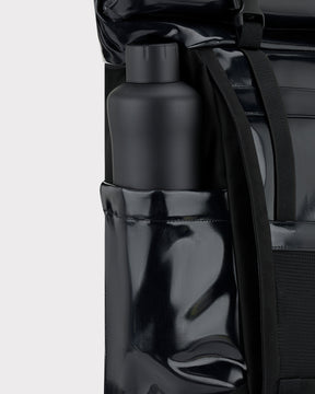 Schwarzer Johnny Urban Rolltop Rucksack 'Ashton' mit glänzendem Material und einer Wasserflasche in der Seitentasche