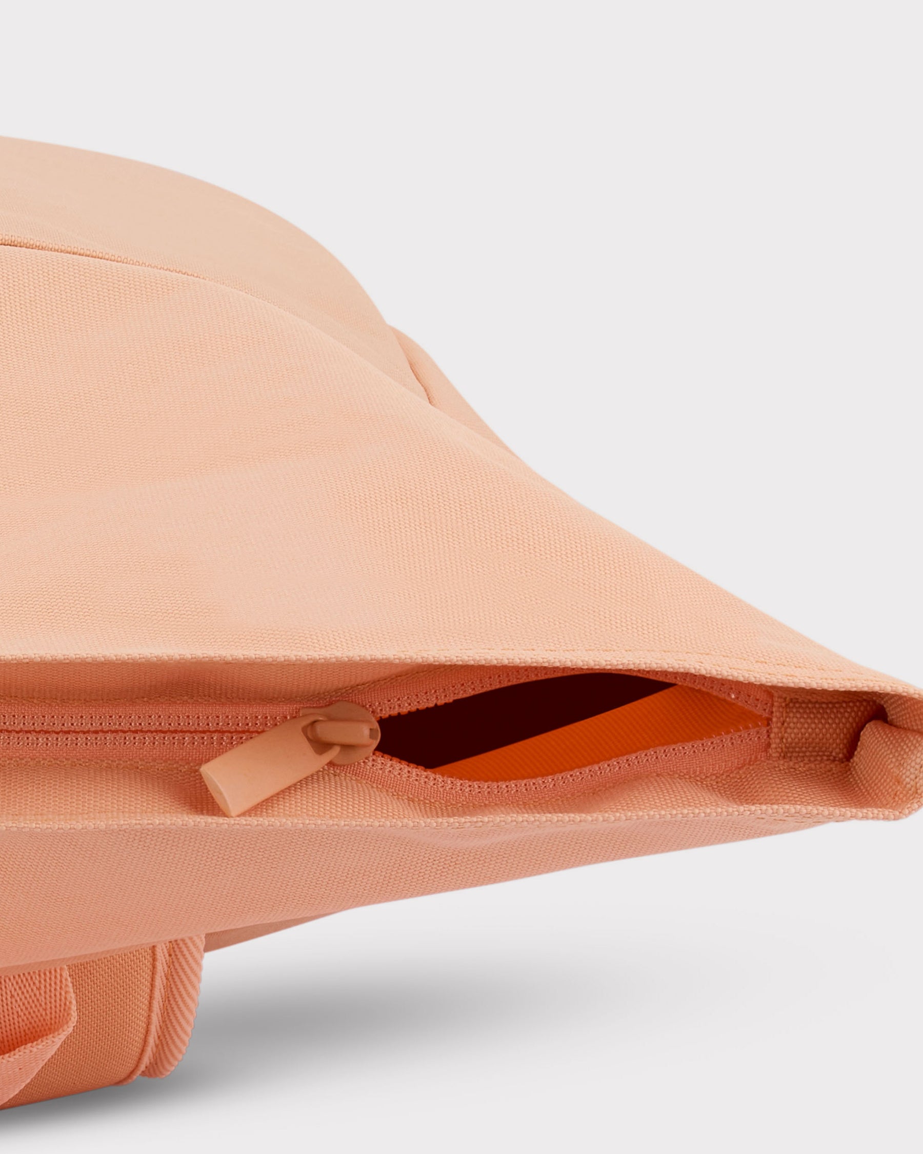 Pfirsichfarbener Rolltop-Rucksack "Robin Medium" mit geöffnetem Reißverschlussfach seitlich