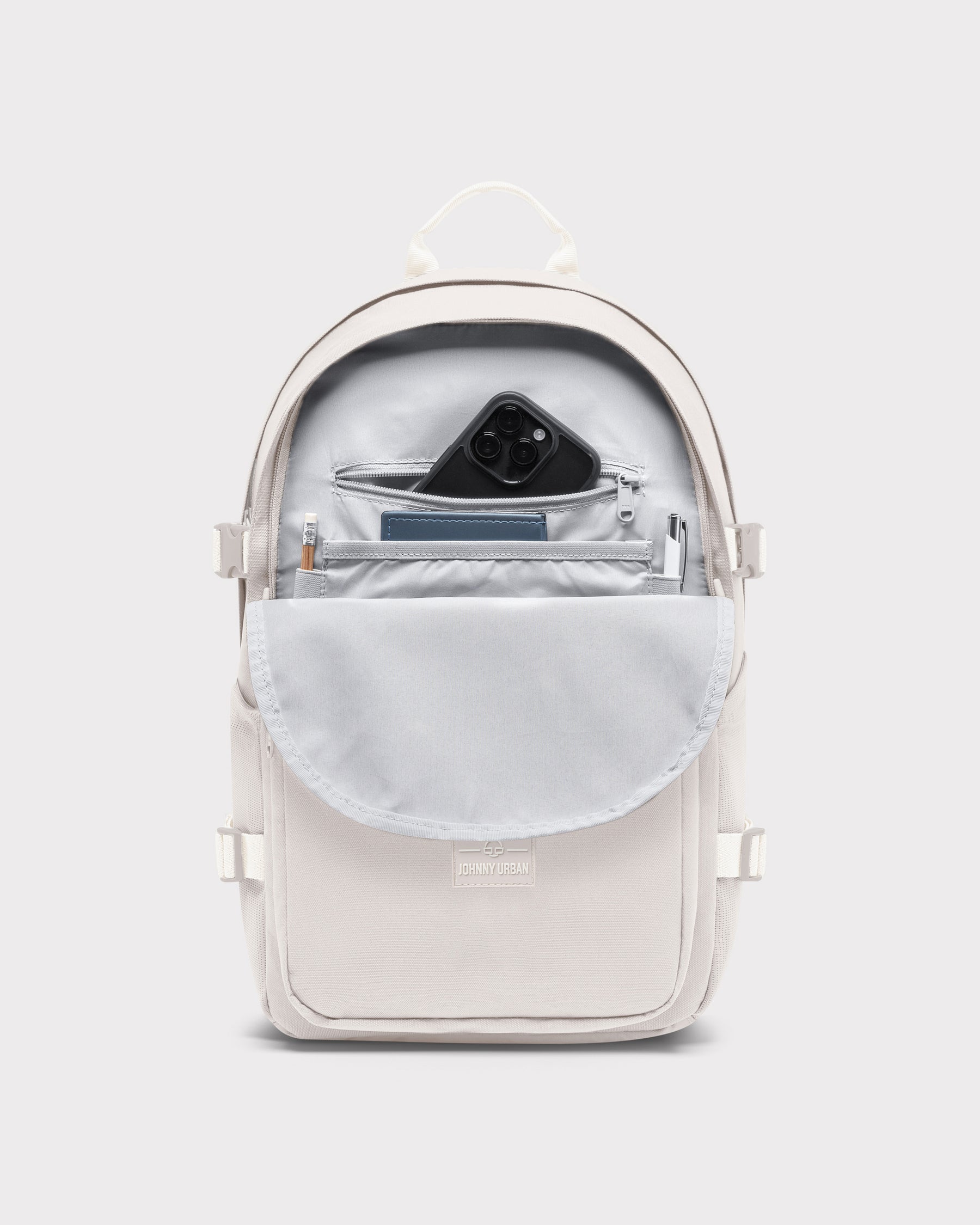 Ergonomischer Schulrucksack 'Lian' in Sandfarbe mit geöffnetem Frontfach, innen Smartphone, Notizbuch, Stift und Bleistift