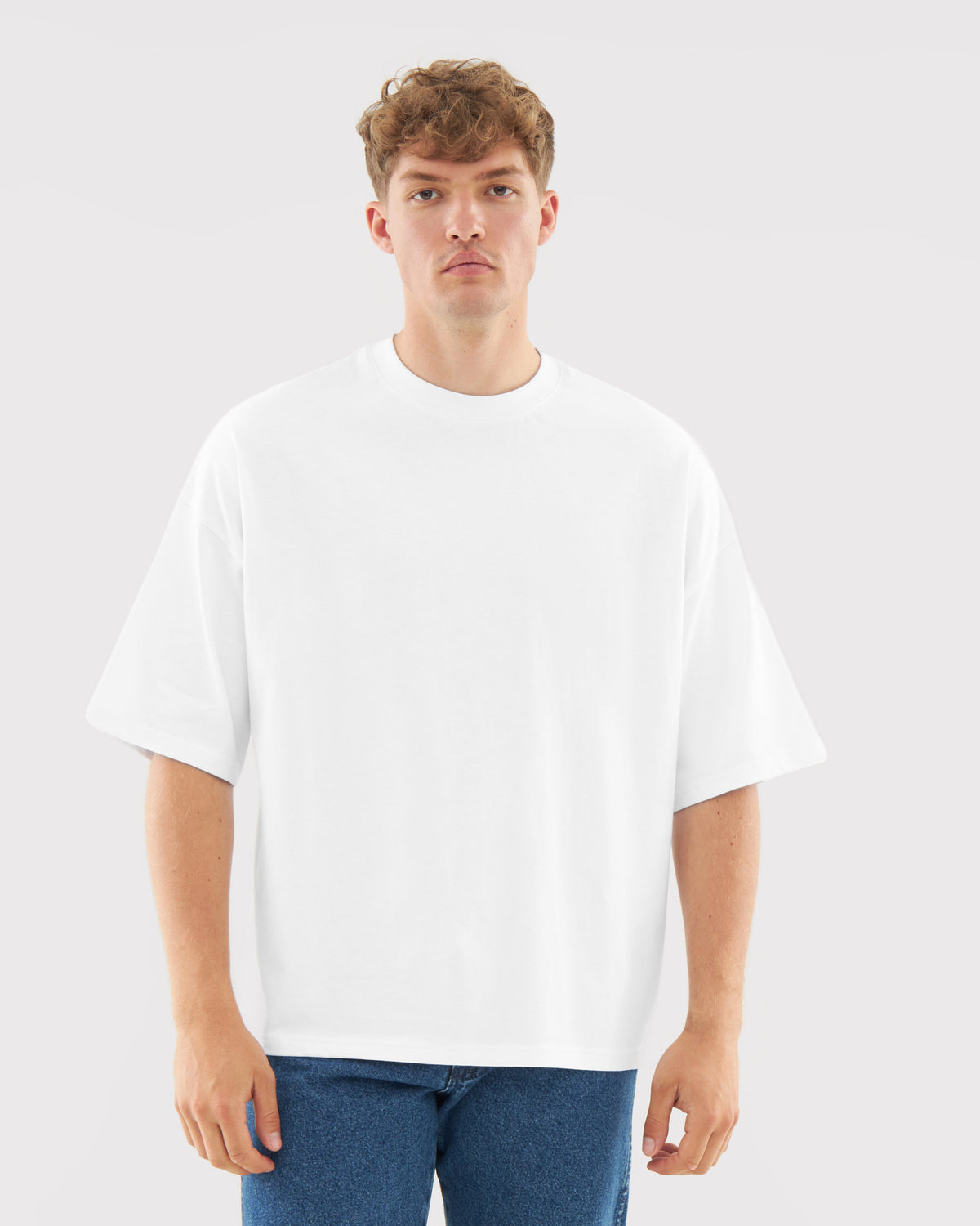 Mann trägt weißes T-Shirt 'Vic' mit lockerer Passform und kurzen Ärmeln