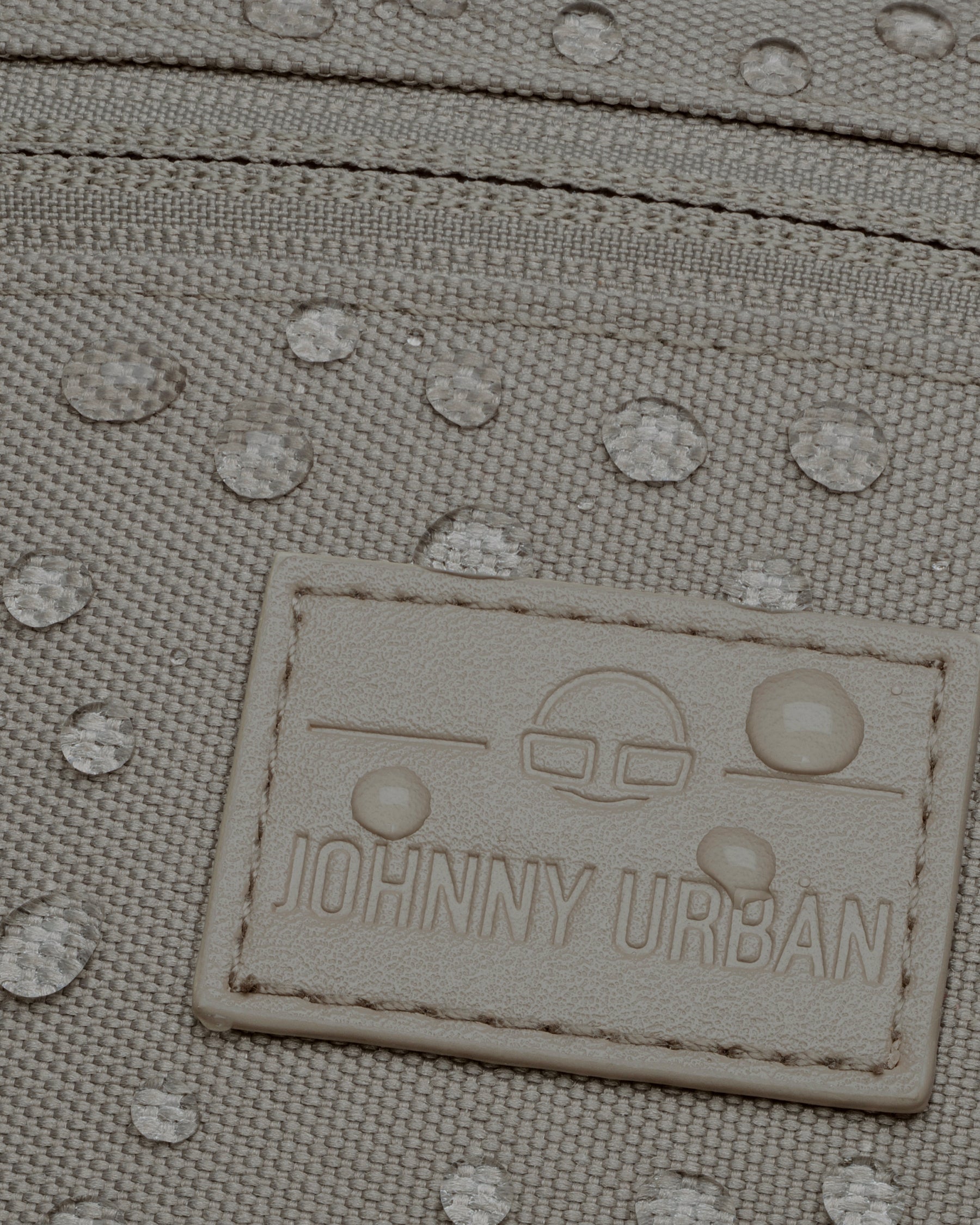 Wasserabweisende hellgraue Bauchtasche 'Ben' von Johnny Urban mit sichtbaren Wassertropfen und Markenetikett