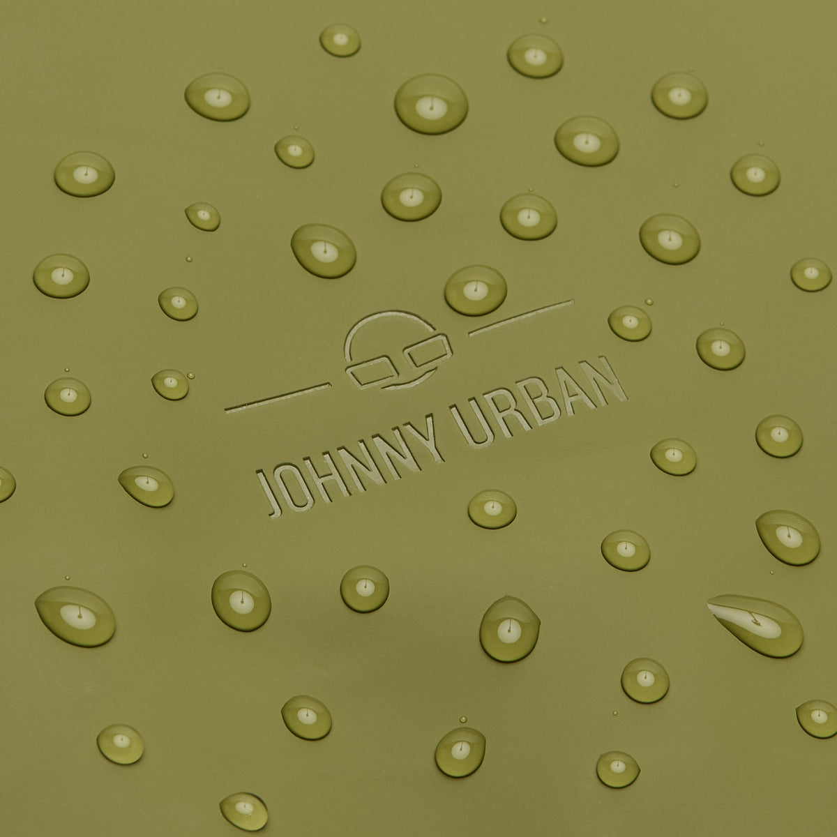 Nahe Aufnahme der wasserabweisenden Oberfläche des olivgrünen Rolltop Rucksacks 'Henry' mit eingelassenem Johnny Urban Logo und Wassertropfen