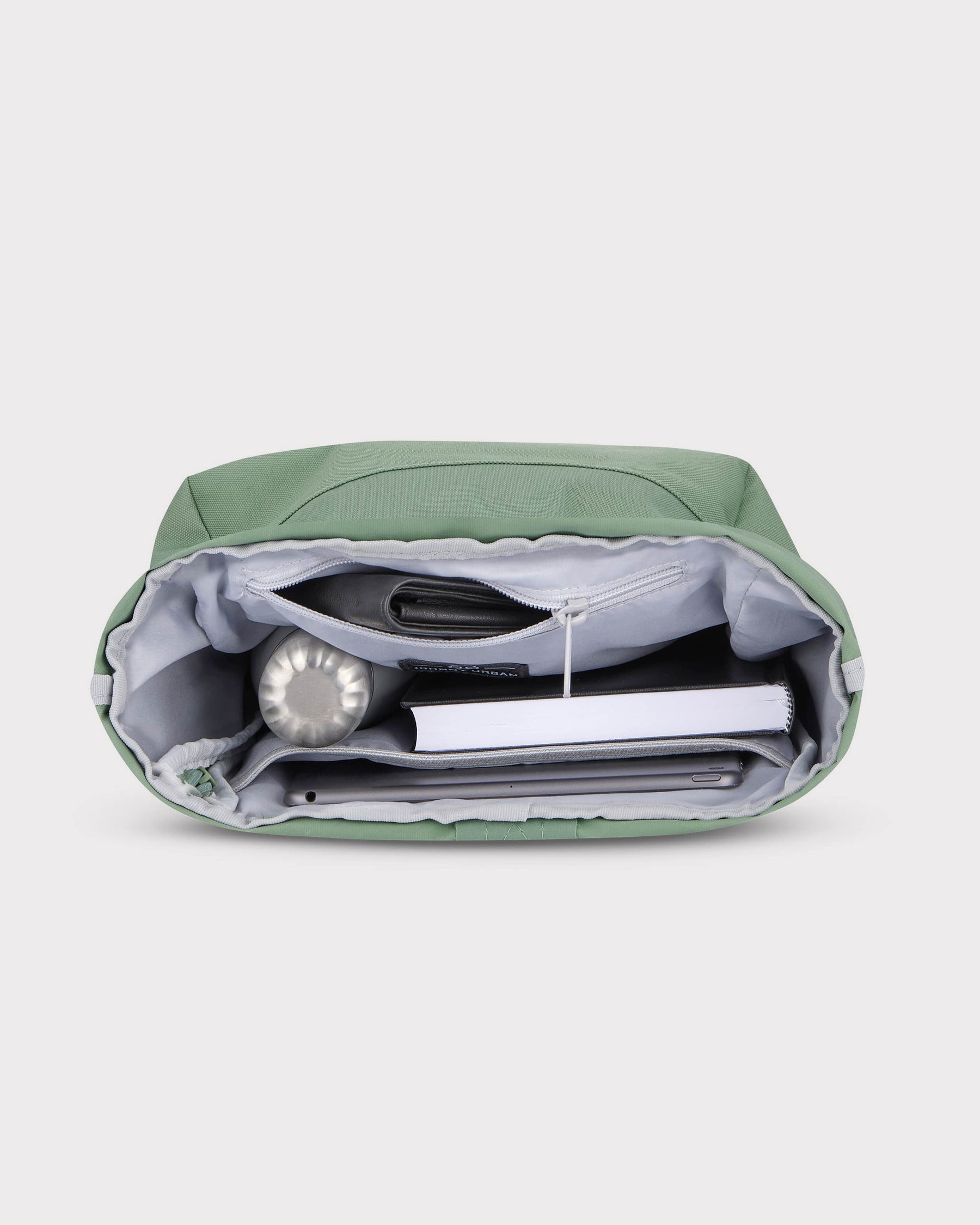Innenansicht des grünen Rolltop Rucksacks 'Robin Small' mit Laptop, Buch, Wasserflasche und Geldbörse