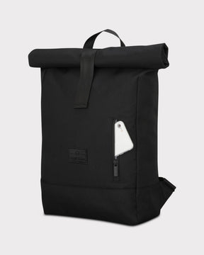 Schwarzer Rolltop Rucksack 'Robin Medium' von Johnny Urban mit Außentasche, darin ein Smartphone