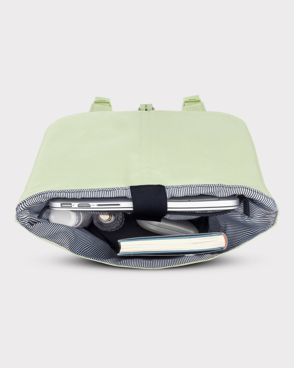 Heller Damenrucksack 'Mia' in Lime mit gestreiftem Innenfutter, gefüllt mit Laptop, Buch und Alltagsgegenständen